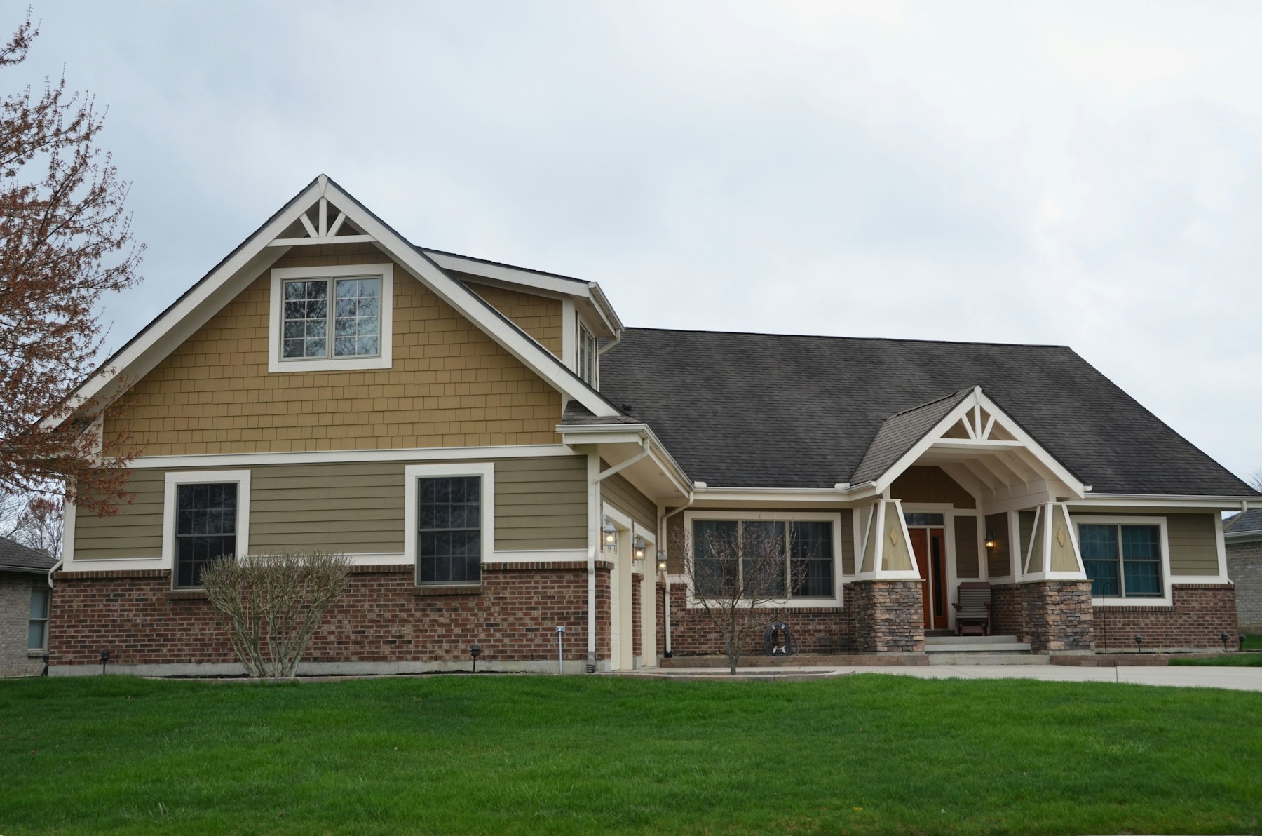 A finished craftsman-style home with stone accents and trim detail.